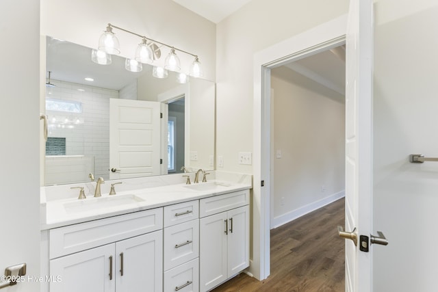 bathroom featuring hardwood / wood-style floors, vanity, and a tile shower