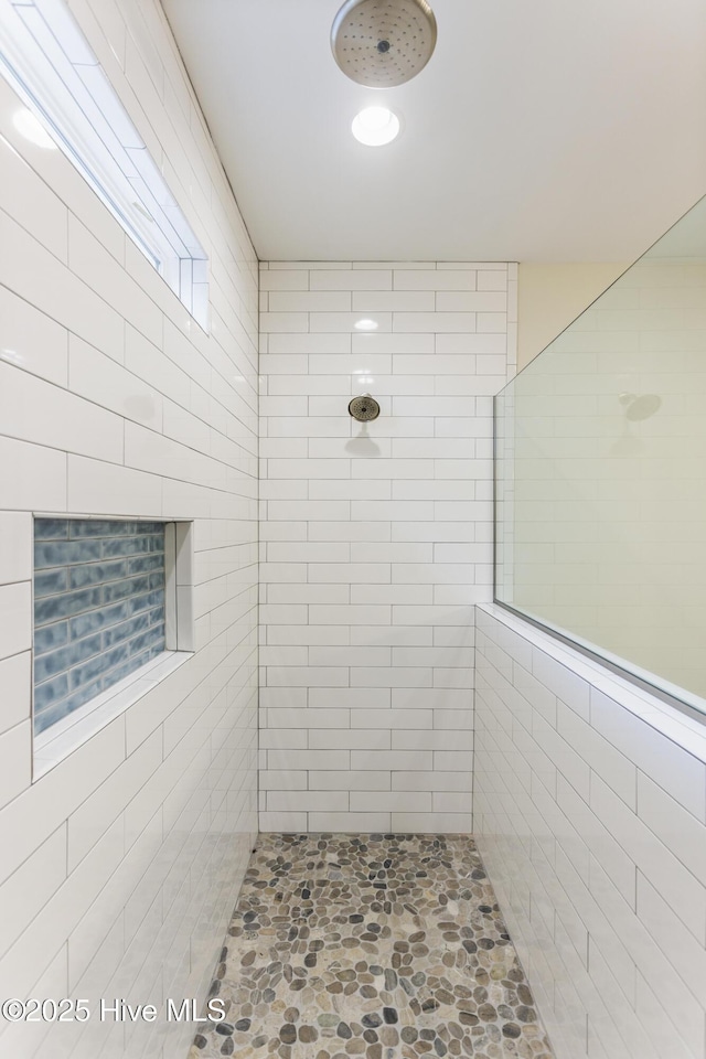 bathroom with tiled shower