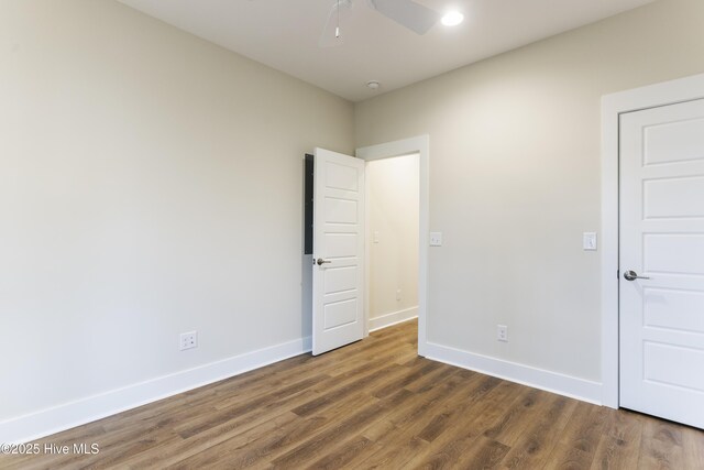 131 NW 18th St, Oak Island, NC 28465 - unfurnished bedroom with baseboards, dark wood-style floors, ceiling fan, and recessed lighting