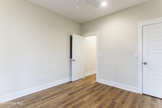 spare room featuring ceiling fan and dark hardwood / wood-style floors