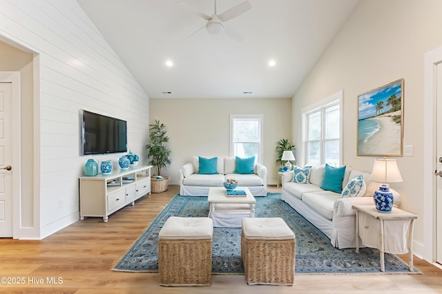 131 NW 18th St, Oak Island, NC 28465 - living area featuring a ceiling fan, light wood-style flooring, wood walls, recessed lighting, and high vaulted ceiling