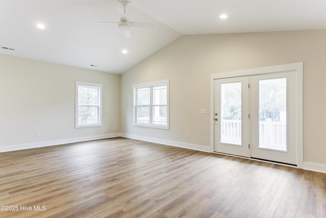 unfurnished living room featuring lofted ceiling, ceiling fan, and light wood-type flooring