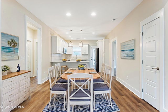 131 NW 18th St, Oak Island, NC 28465 - dining area featuring light wood-type flooring, baseboards, and recessed lighting