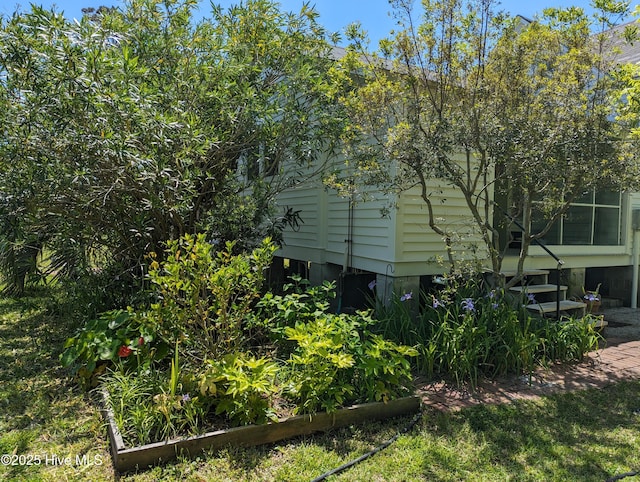 view of property exterior featuring a garden