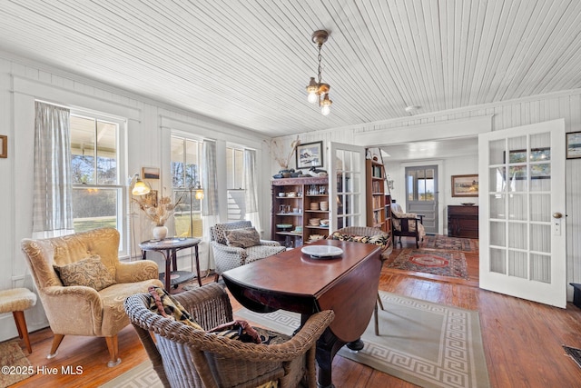 interior space featuring french doors, a healthy amount of sunlight, and wood-type flooring