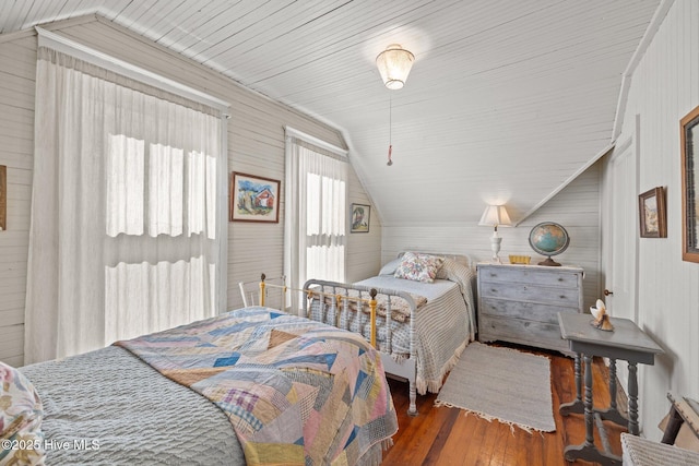 bedroom featuring hardwood / wood-style floors and lofted ceiling