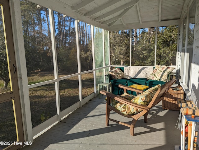 sunroom with lofted ceiling with beams, wood ceiling, and a healthy amount of sunlight