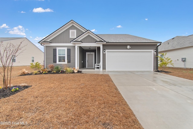 view of front of house with a garage, a front lawn, board and batten siding, and driveway