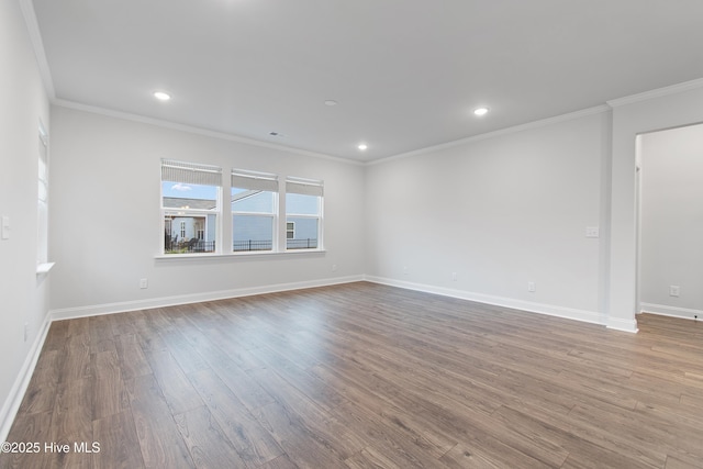 spare room with crown molding and light wood-type flooring