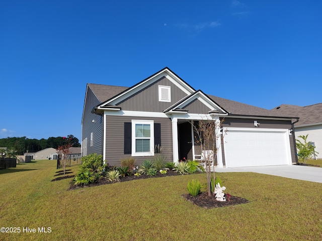 view of front of home featuring a garage, driveway, and a front lawn