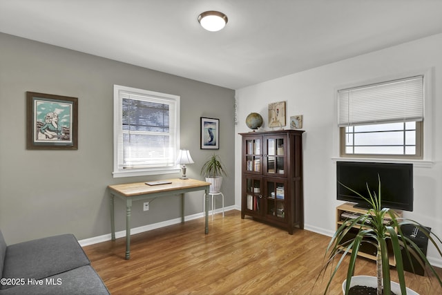 office area featuring plenty of natural light, light wood-style flooring, and baseboards