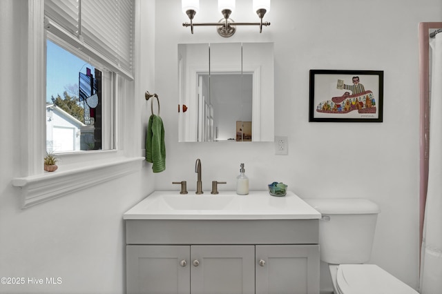 bathroom featuring toilet and vanity