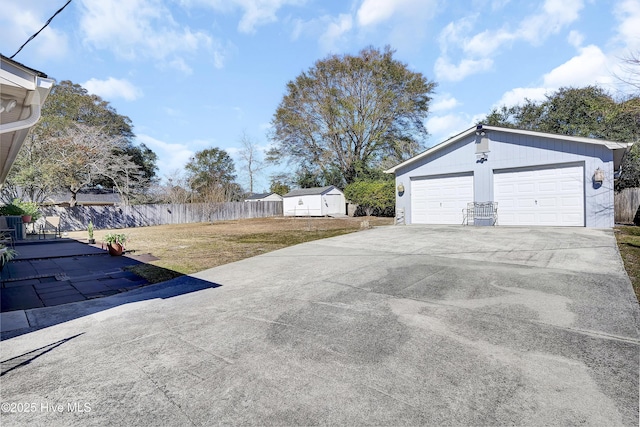 view of yard featuring an outdoor structure and fence