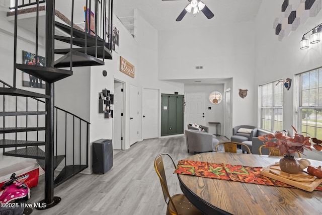 dining room with ceiling fan and light hardwood / wood-style flooring