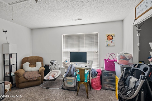 interior space featuring a textured ceiling and carpet flooring