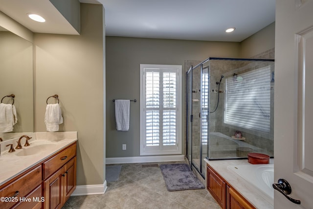 bathroom with plus walk in shower, vanity, and tile patterned flooring