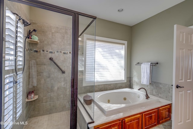 bathroom featuring independent shower and bath