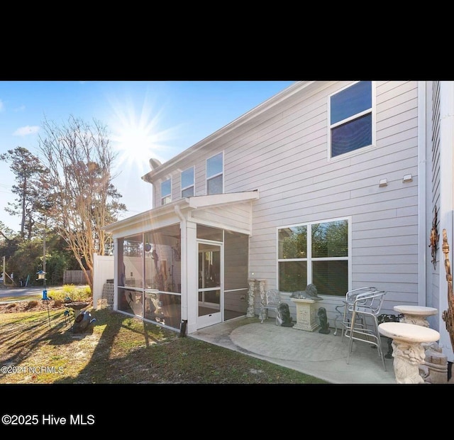 back of house with a patio and a sunroom