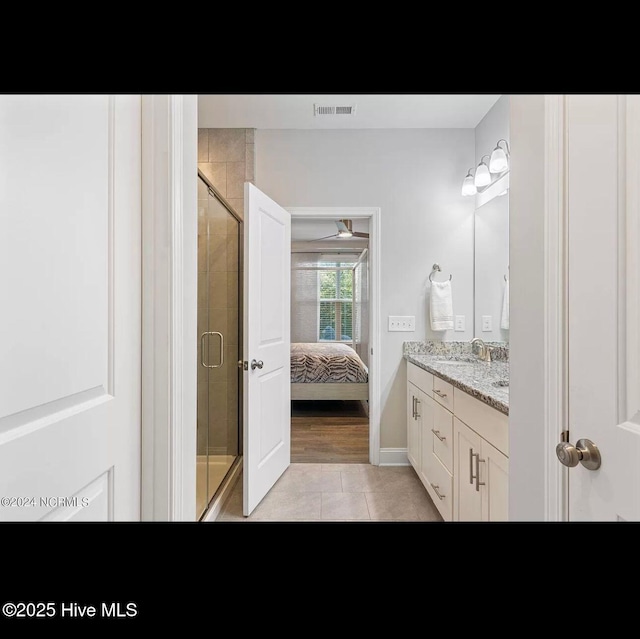 bathroom featuring vanity, an enclosed shower, and tile patterned flooring