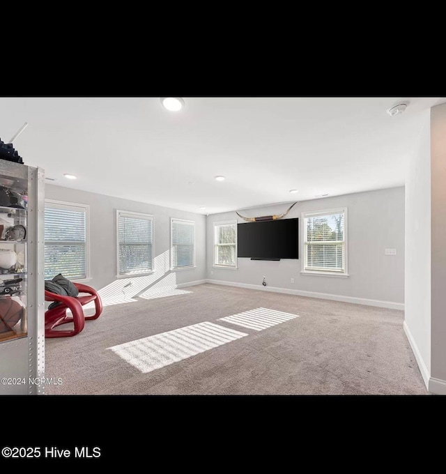 unfurnished living room featuring carpet flooring