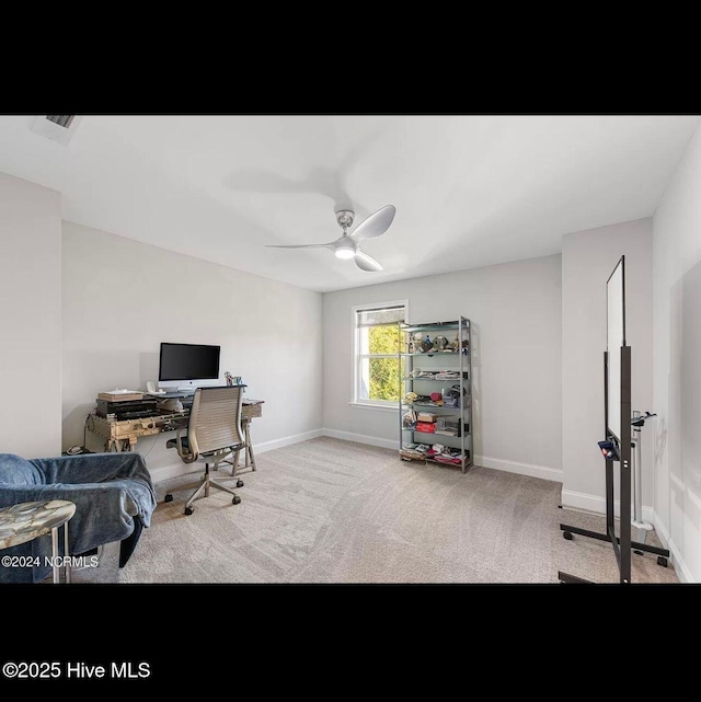 carpeted office featuring ceiling fan