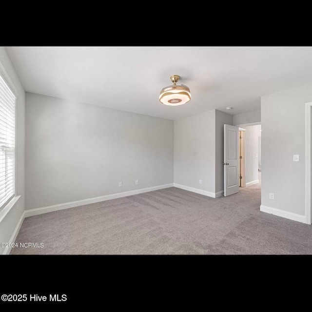 spare room with light colored carpet