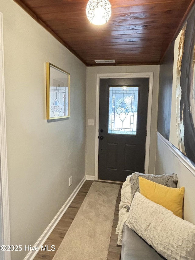 interior space with hardwood / wood-style flooring and wood ceiling