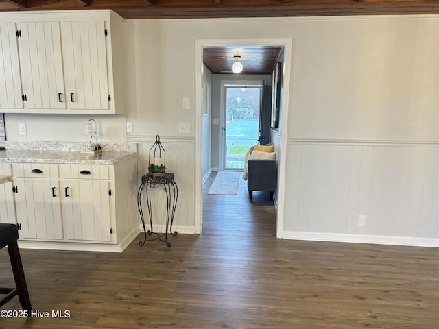 kitchen featuring white cabinetry and dark hardwood / wood-style floors