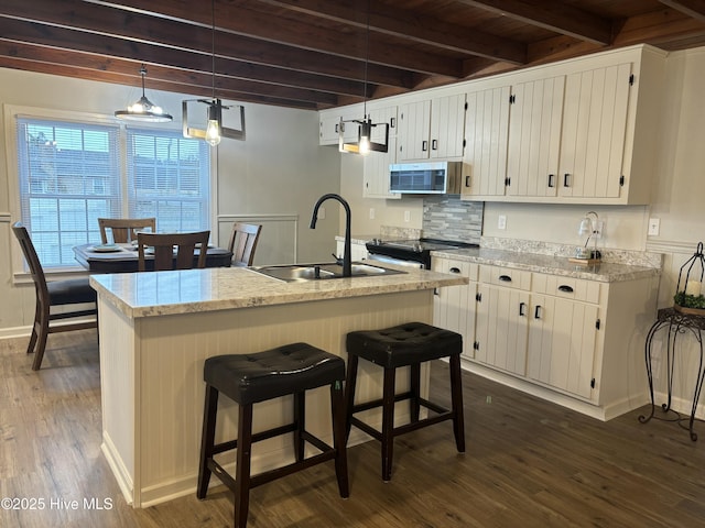 kitchen with pendant lighting, sink, and white cabinets