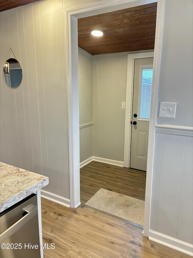 interior space featuring vanity, hardwood / wood-style floors, and wooden ceiling