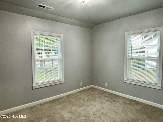 spare room with light carpet