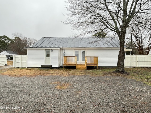 rear view of property with french doors and a deck