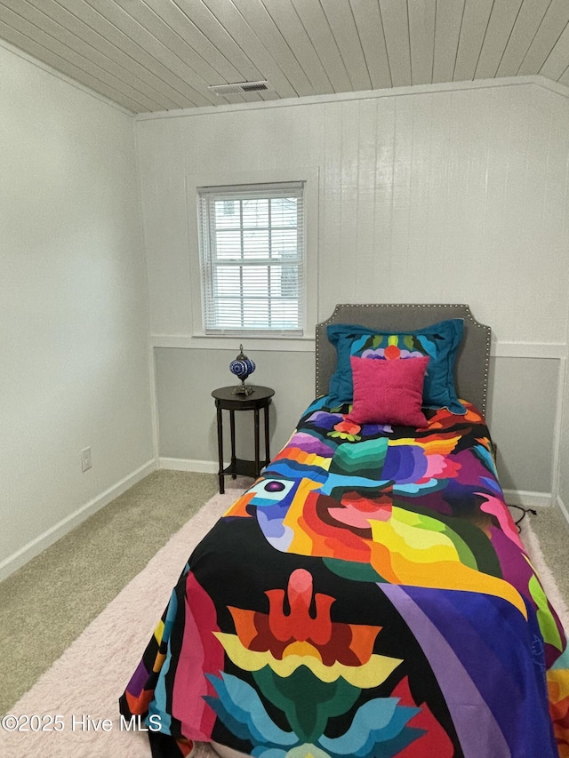 bedroom with wood ceiling and carpet flooring