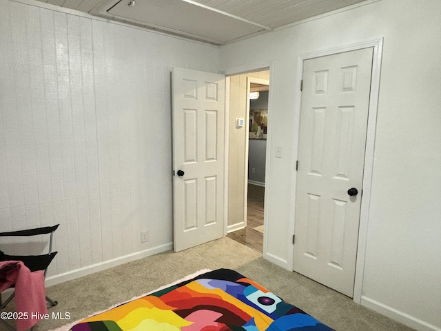 playroom featuring light carpet and wood walls