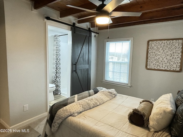 carpeted bedroom with wood ceiling, ensuite bath, beamed ceiling, ceiling fan, and a barn door