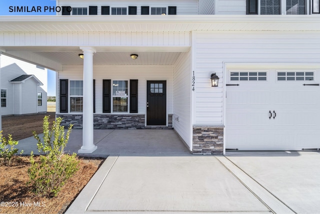 entrance to property featuring a porch and a garage