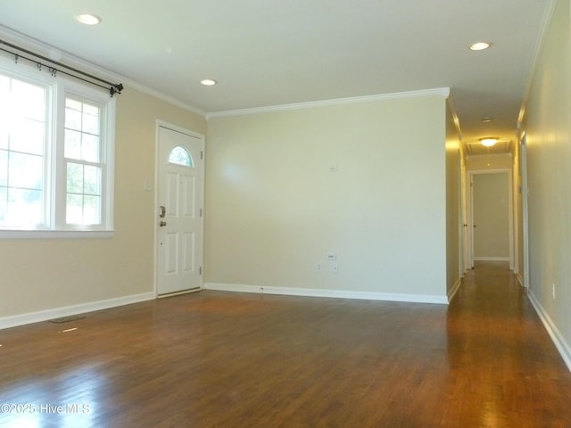 foyer entrance featuring crown molding and dark hardwood / wood-style floors
