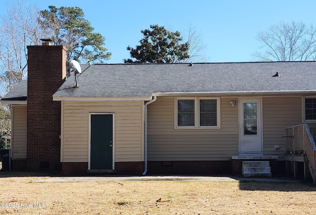rear view of house featuring a lawn