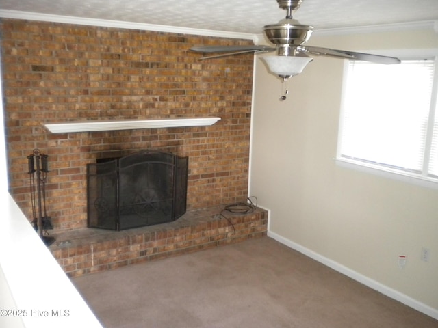unfurnished living room featuring a fireplace, ornamental molding, carpet flooring, and ceiling fan