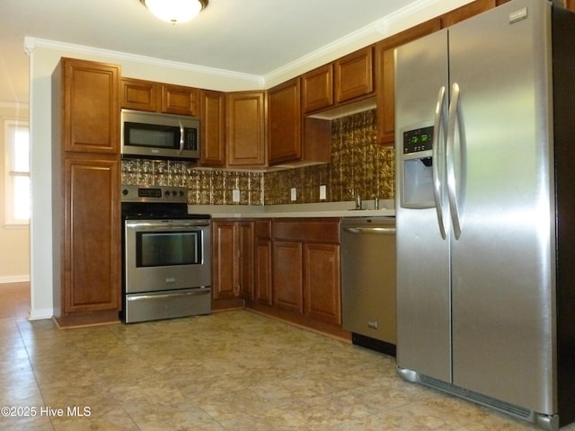 kitchen with stainless steel appliances, ornamental molding, and decorative backsplash