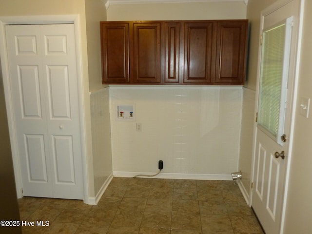 washroom with washer hookup and cabinets