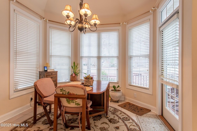 tiled dining area featuring an inviting chandelier