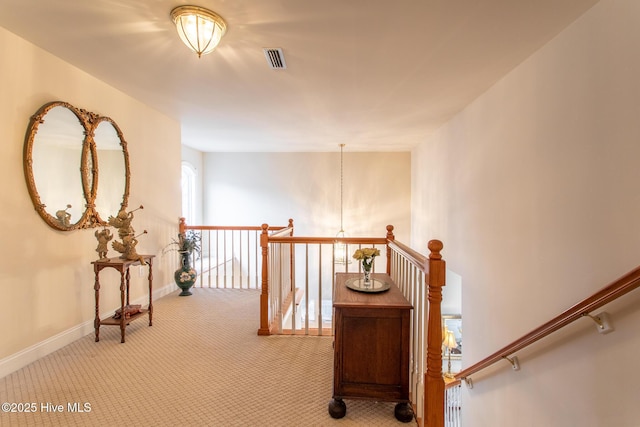 hall featuring light colored carpet