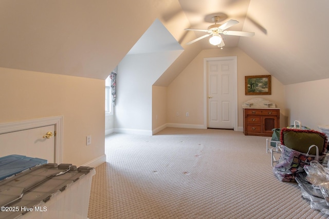 additional living space with lofted ceiling, light carpet, and ceiling fan