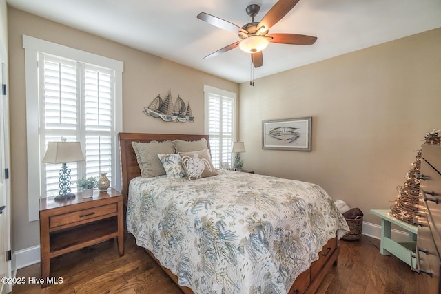 bedroom with ceiling fan, baseboards, and wood finished floors