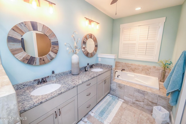 bathroom with ceiling fan, double vanity, a sink, and a bath