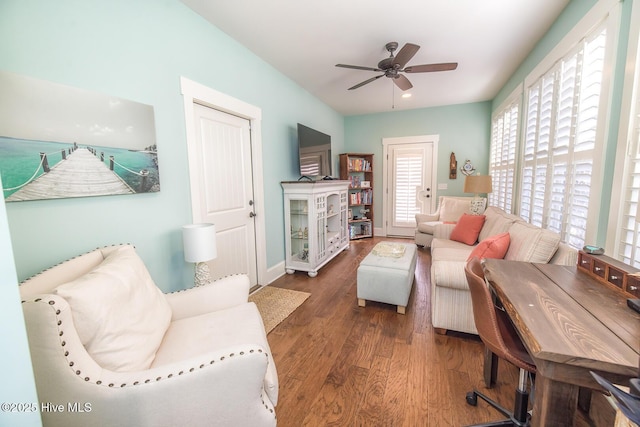 living area featuring ceiling fan, wood finished floors, and baseboards