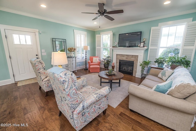 living area with crown molding, wood finished floors, and recessed lighting