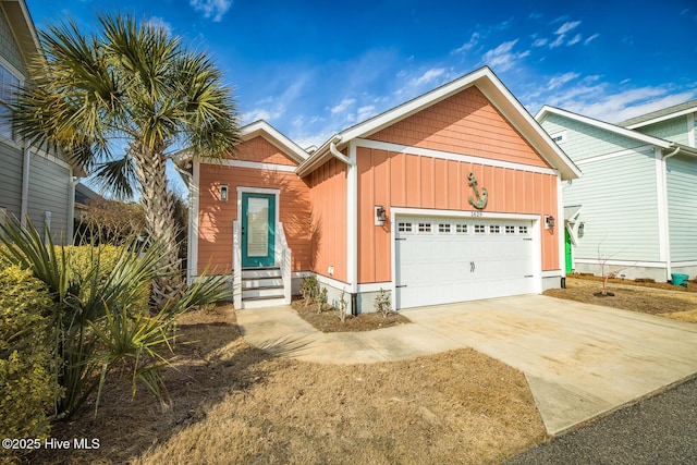 view of front of house with a garage, entry steps, concrete driveway, and board and batten siding