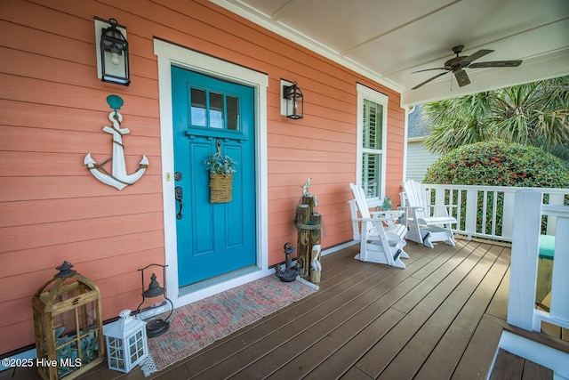 doorway to property featuring a porch and a ceiling fan